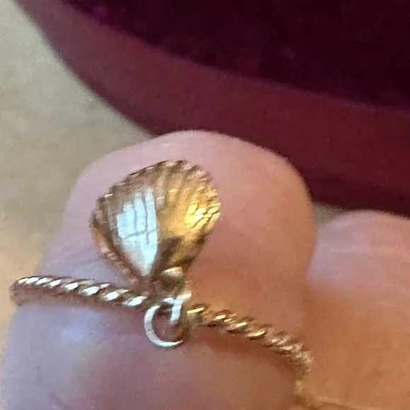 14 karat yellow gold cable ring with a beautiful shell hanging